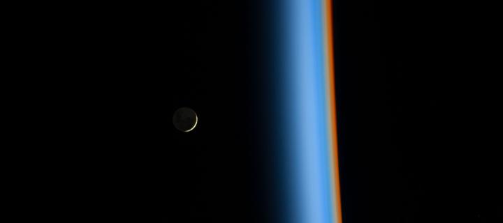Crescent moon rising and the cusp of Earth's atmosphere
