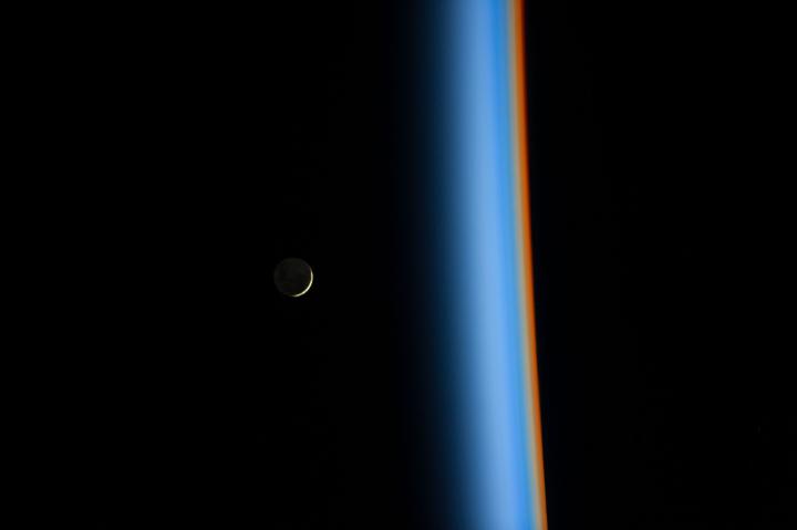 Crescent moon rising and the cusp of Earth's atmosphere